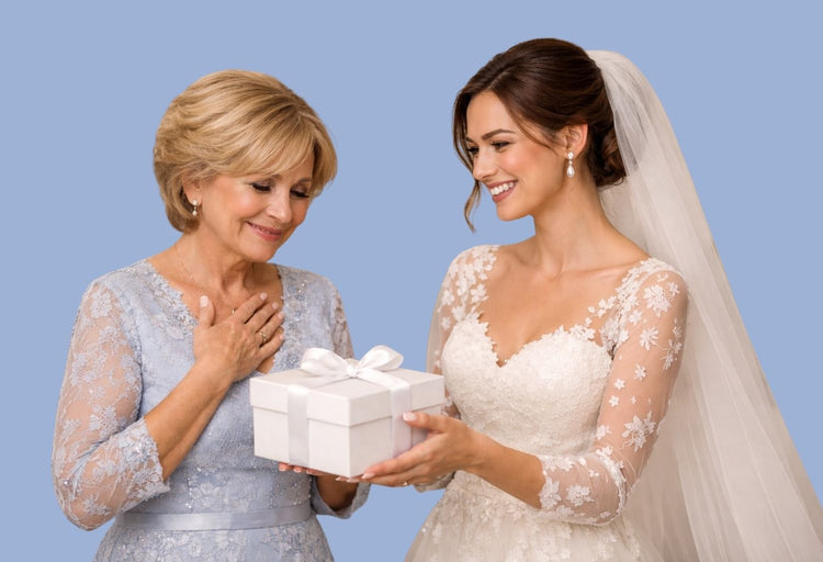 Braut überreicht ihrer Mutter eine weiße Geschenkbox – emotionaler Moment bei der Hochzeit, Mutter gerührt, Tochter strahlt, stilvolle Hochzeitsfotografie im warmen Licht.