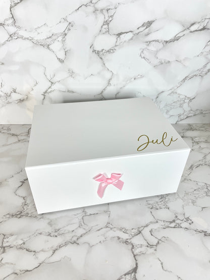 Weiße Geschenkbox mit rosa Schleife, Magnetverschluss und personalisiertem Namensaufdruck.