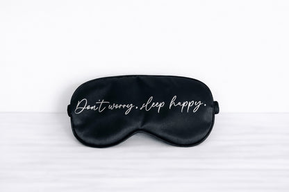 Schwarze Schlafmaske mit Aufdruck "Don't worry sleep happy"
